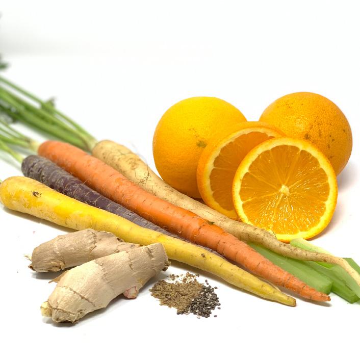 Fresh ingredients including carrots, ginger, and oranges used for Cyan Ares brightening exfoliating mask skincare
