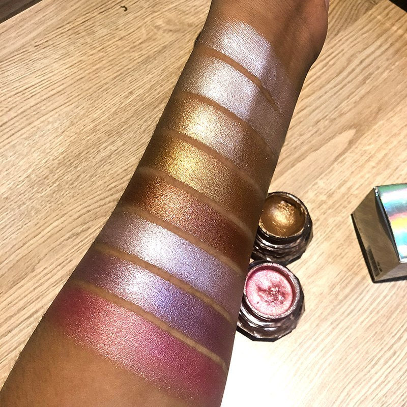 Swatches of Bella Bliss Cosmetics mermaid face highlighter gel on a model's arm showing various shimmering shades